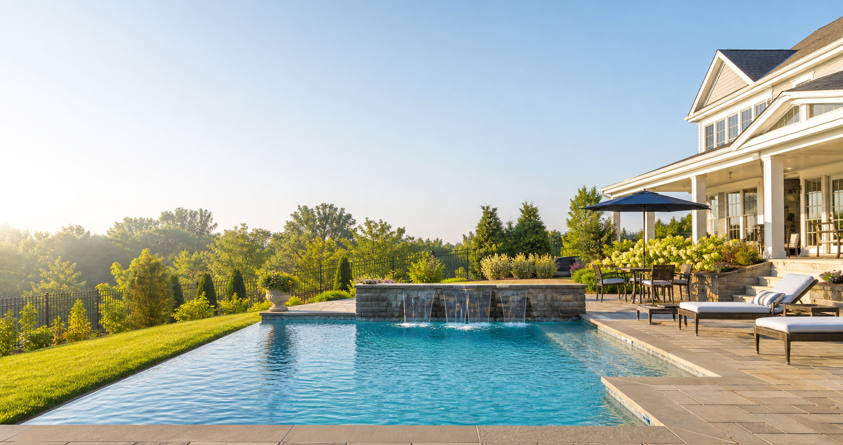 A bright backyard swimming pool with blue water and lounge seating